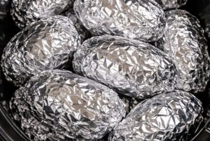 Thumbnail for Wrap raw whole potatoes in tin foil, place them in the slow cooker with a few simple add-ins, and let them cook hands-off all afternoon.