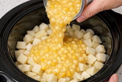 Thumbnail for Pour creamed corn over raw diced potatoes, combined with 2 ingredients, into slow cooker for a creamy side that’s my default when I don’t know what to make.
