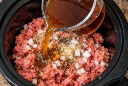 Thumbnail for Pour beef broth over ground beef, together with 3 ingredients, into slow cooker for a comforting dinner that’s my default when I don’t know what to make