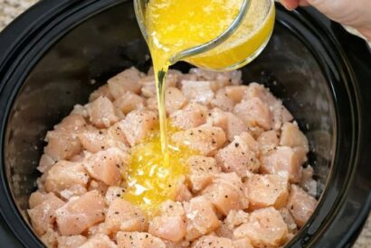 Thumbnail for Pour melted butter over raw diced chicken, together with 3 other ingredients, into slow cooker for a comforting weeknight meal that’s my default when I don’t know what to make.