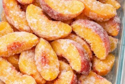 Thumbnail for Dump rock-hard frozen raw peach slices in the casserole dish and 4 other basic pantry items to get a dessert so delicious your friends will be begging for more!