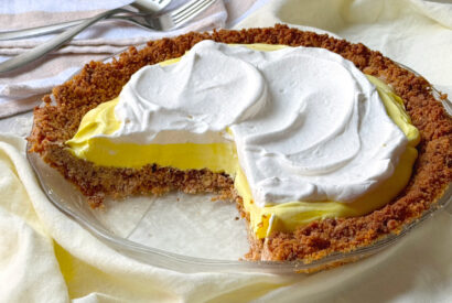 Thumbnail for This vintage pie’s no-fuss prep is as relaxed as the palm trees swaying in a balmy breeze against a colorful, hazy Florida sunset. Creamy Florida Lemon Pie is a simple from-scratch filling gets whipped up and set in the freezer in a graham cracker crumb crust, garnished with ample whipped cream.